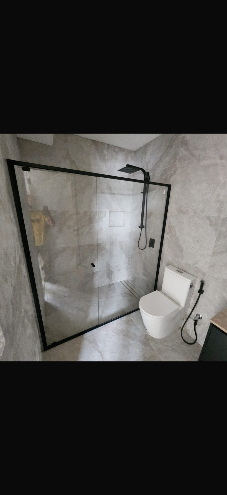 Black-framed frameless shower enclosure — bathroom renovation Sydney