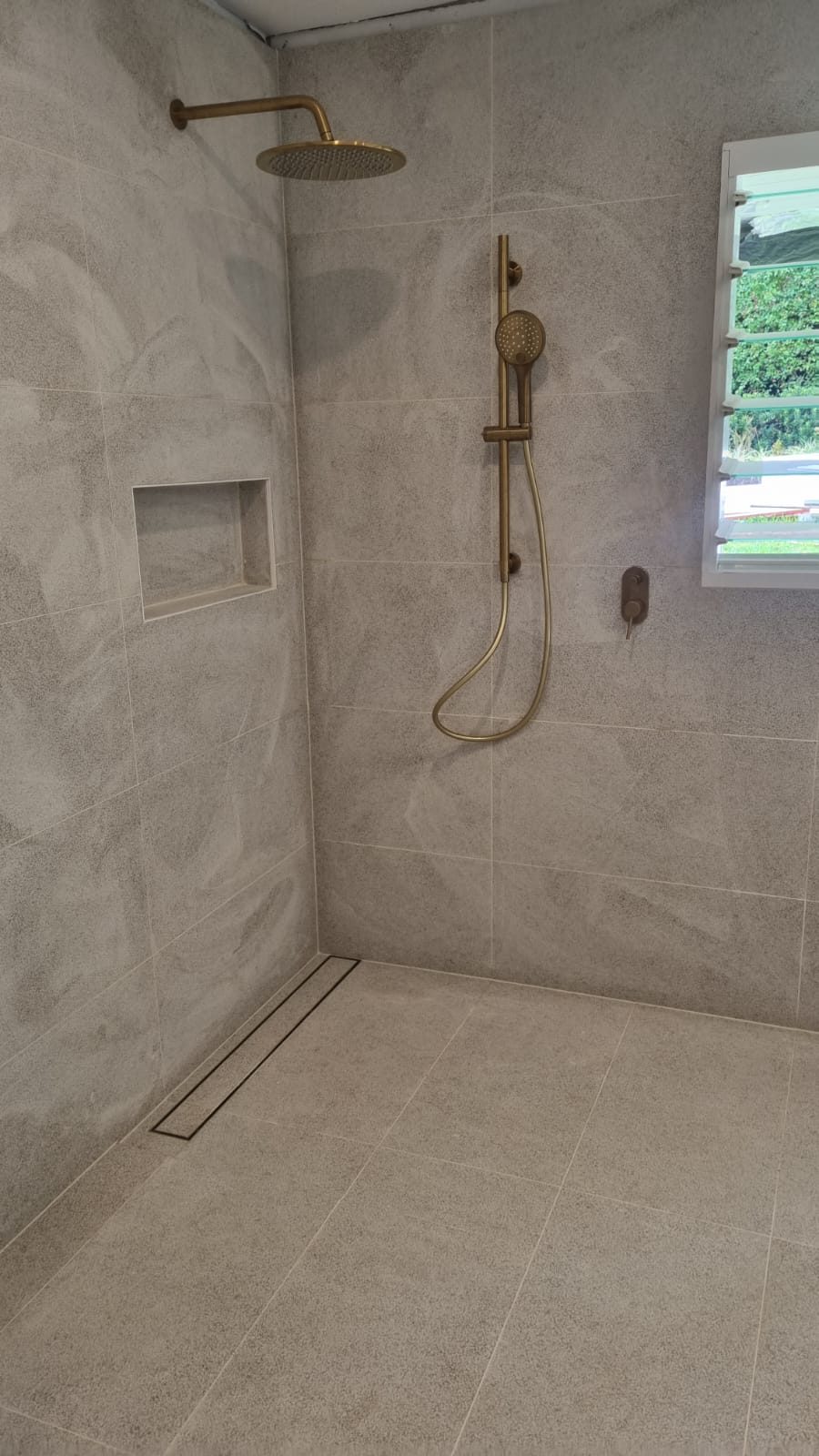 Shower with brass fittings and niche — S & T Tiling Renovations Sydney