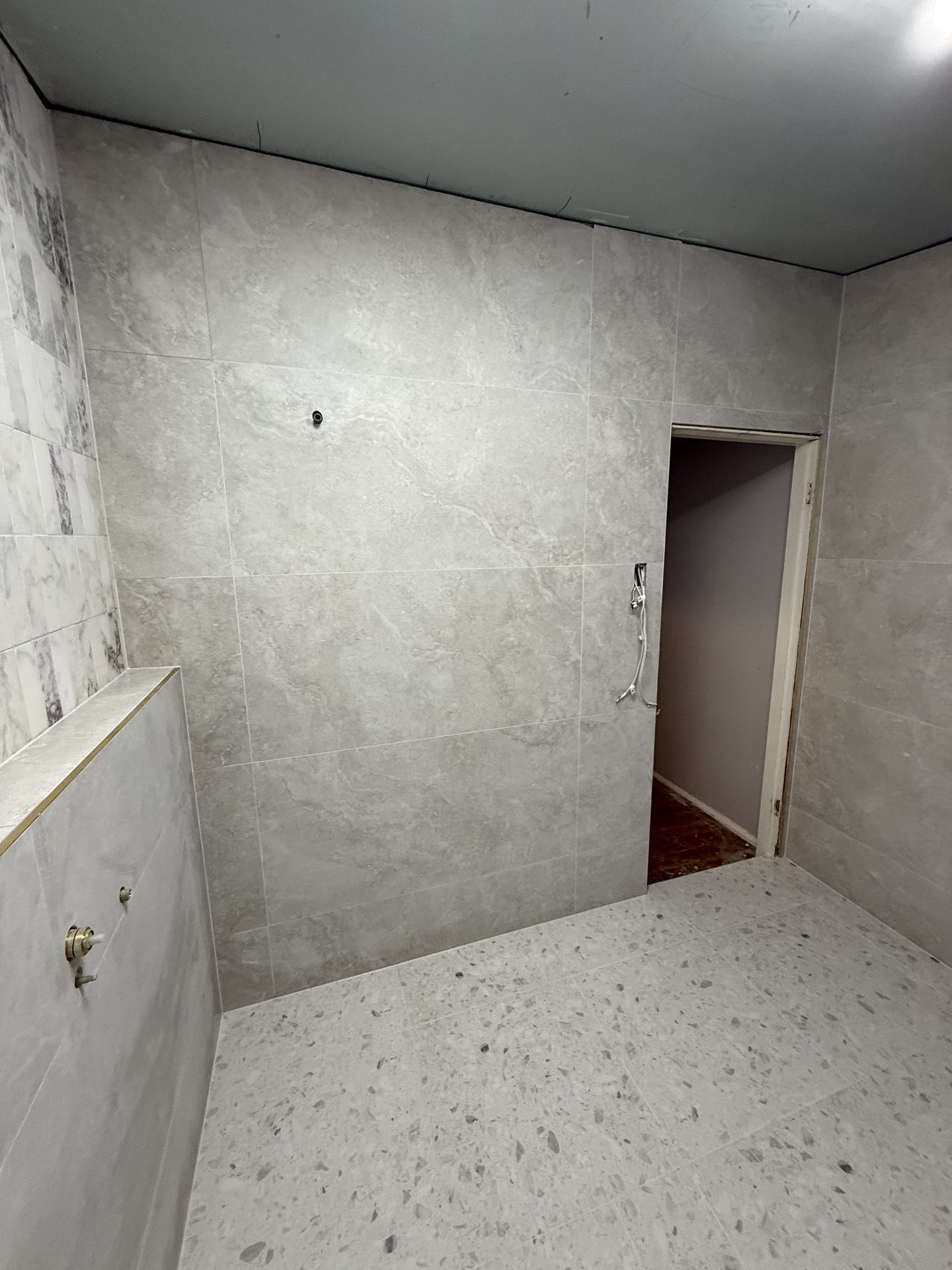 Textured feature wall tiles in bathroom — Sydney tiling project