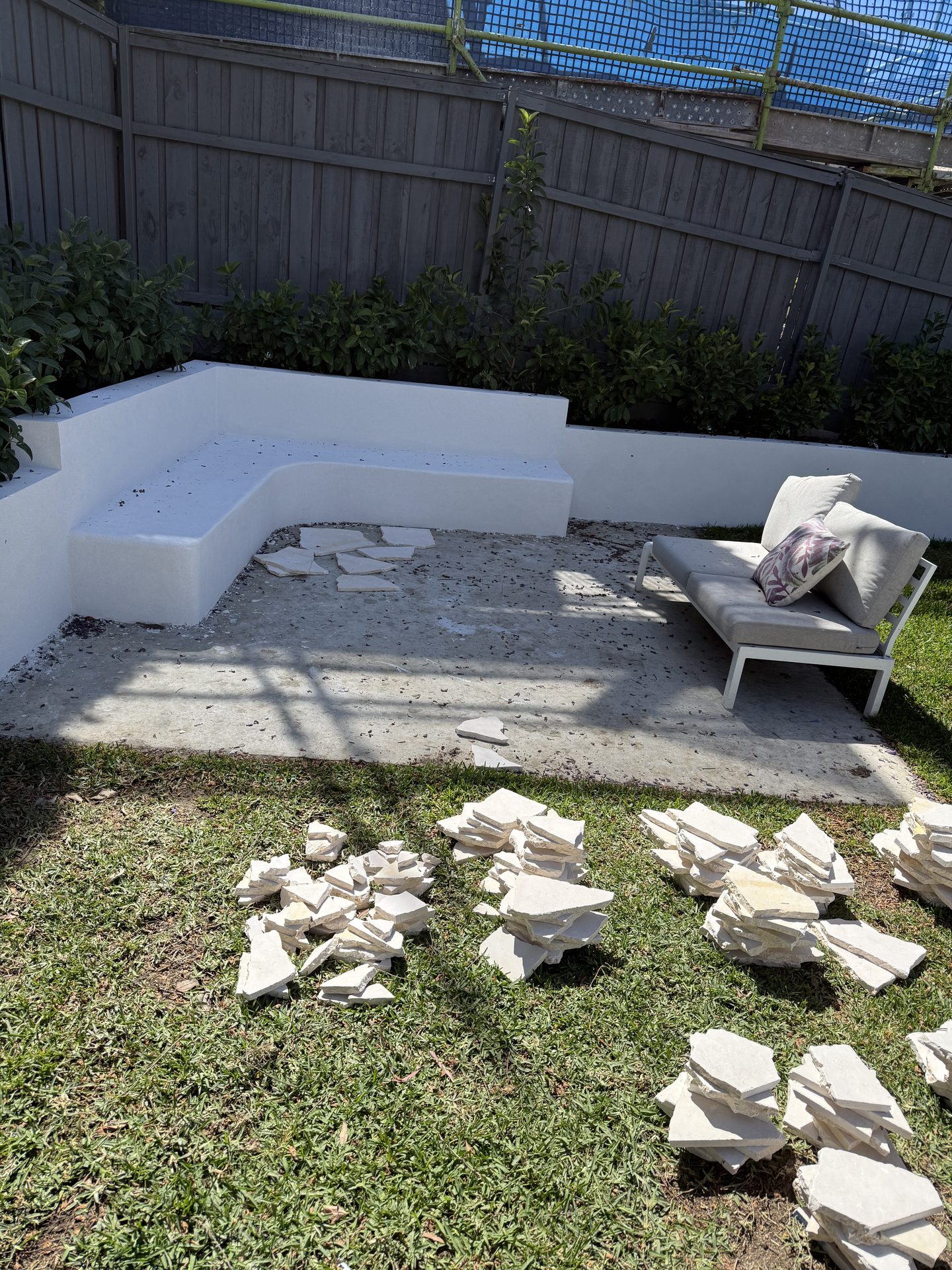 Outdoor courtyard with old crazy paving ripped up before tiling Sydney