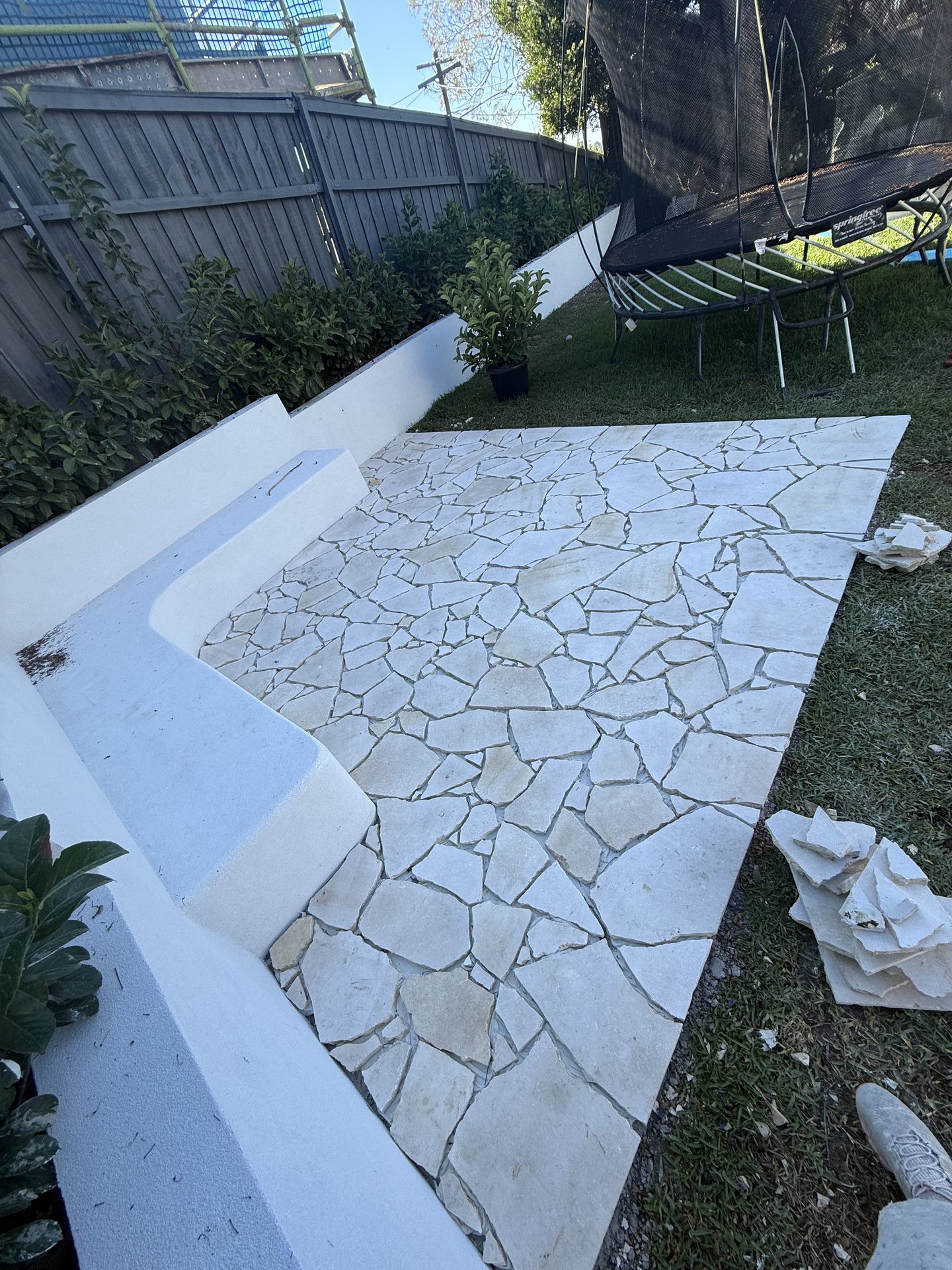 Outdoor courtyard with fresh crazy paving installed after tiling Sydney
