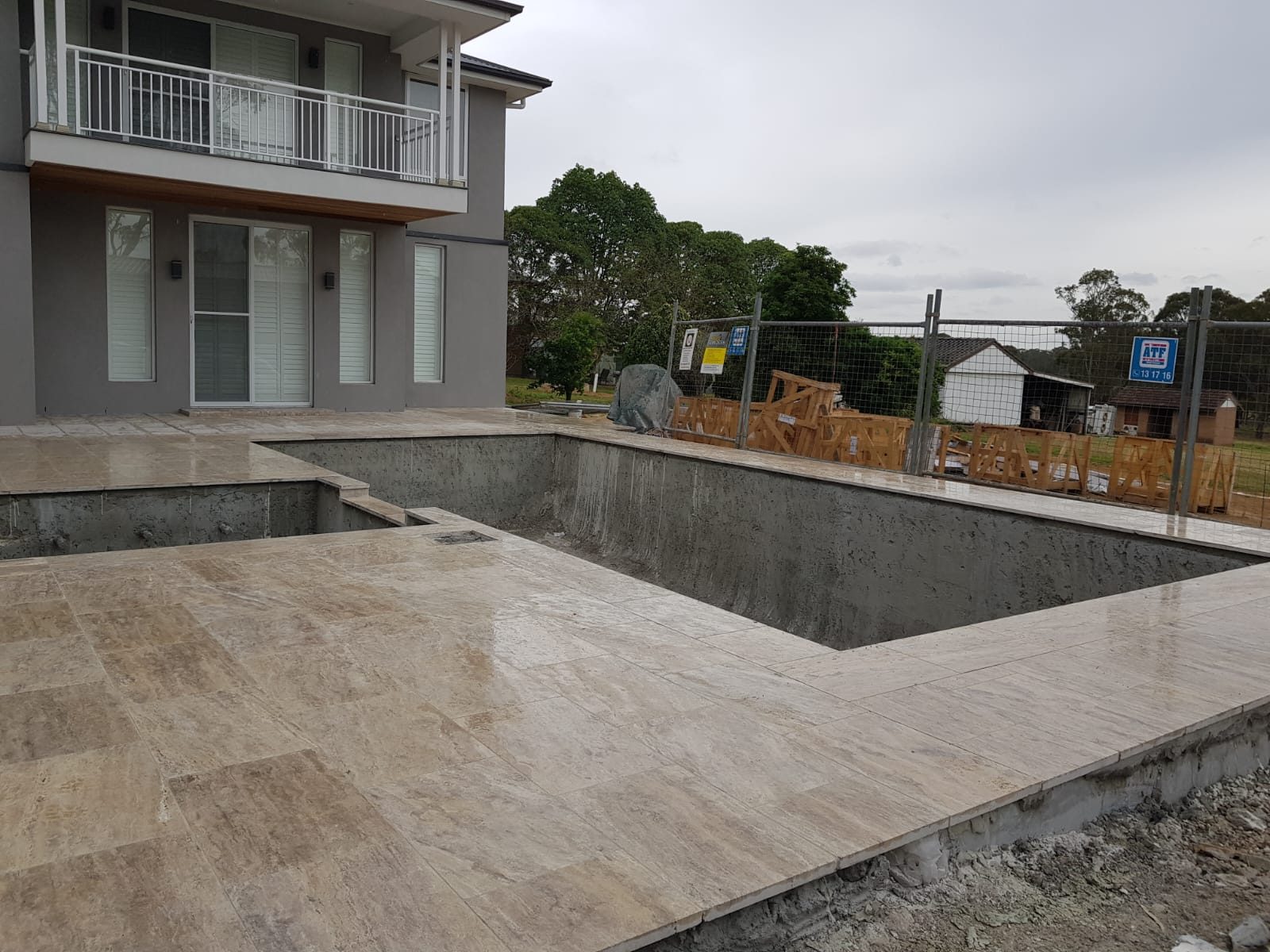Travertine pool coping and waterline tiles — pool tiling Sydney