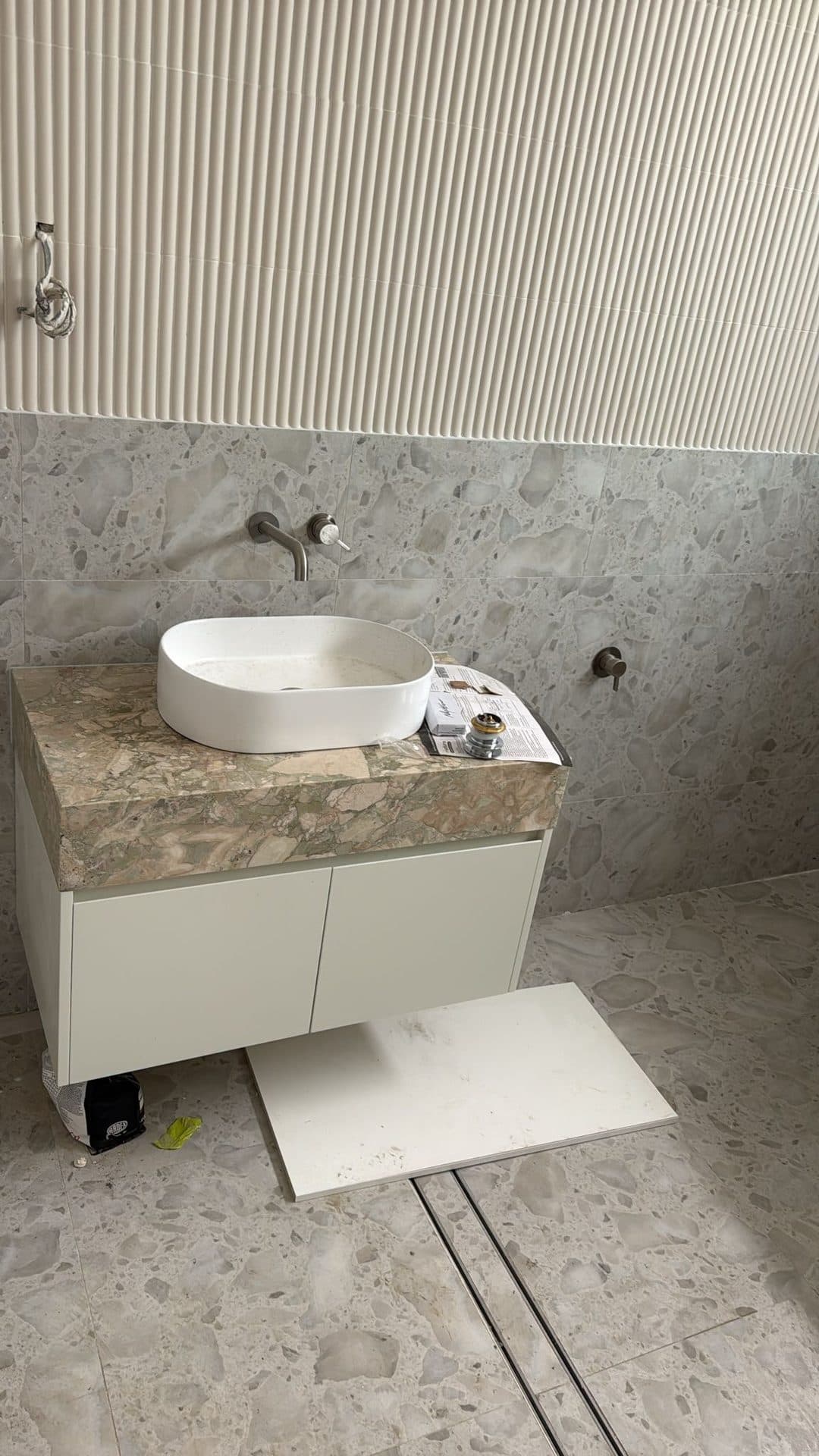 Vessel sink vanity with ribbed feature wall — bathroom renovation Sydney