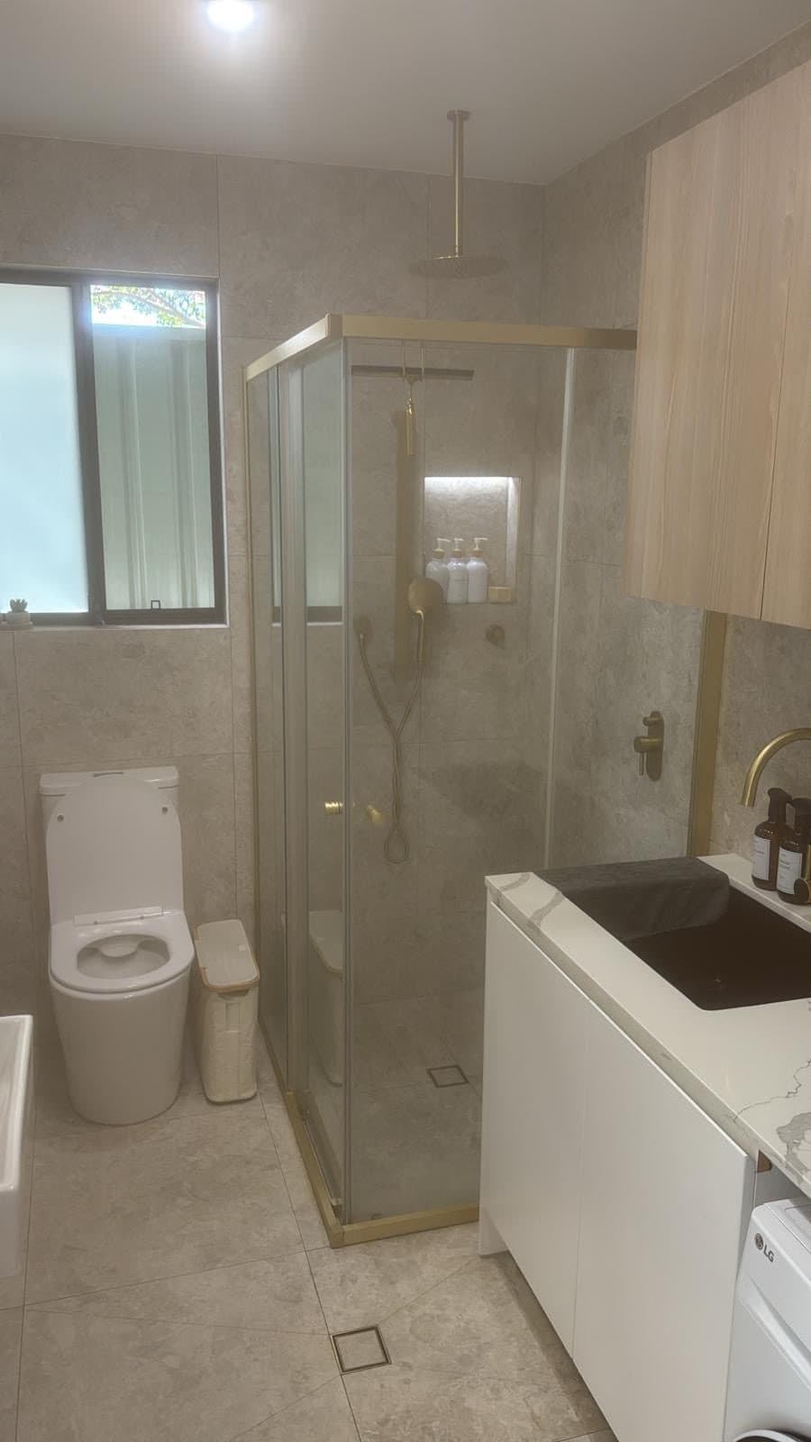 Full bathroom renovation with brass fittings and floor-to-ceiling tiles Sydney