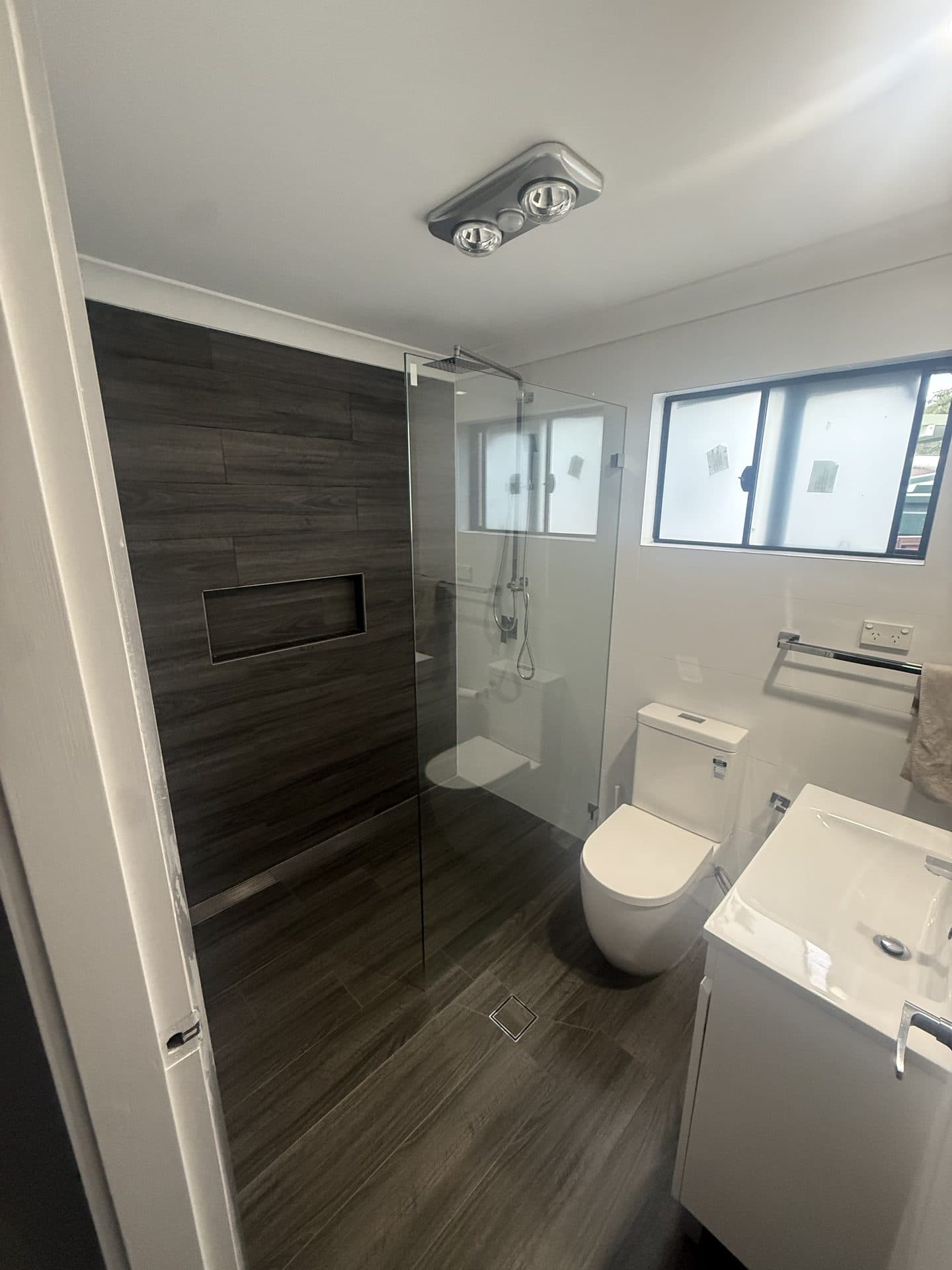 Modern bathroom renovation with large format wall tiles Sydney