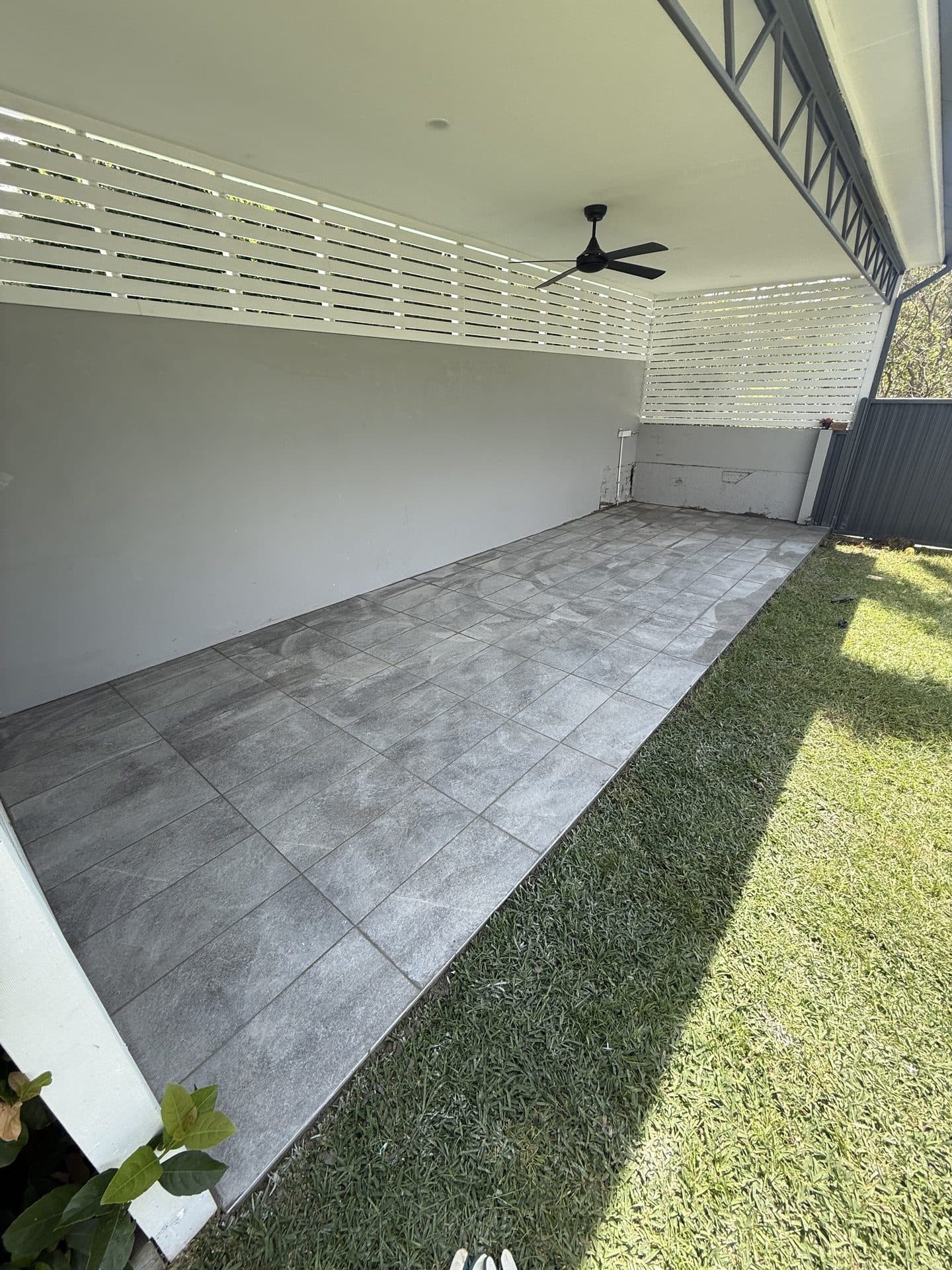 Covered alfresco area with stone-look tiles after tiling Sydney
