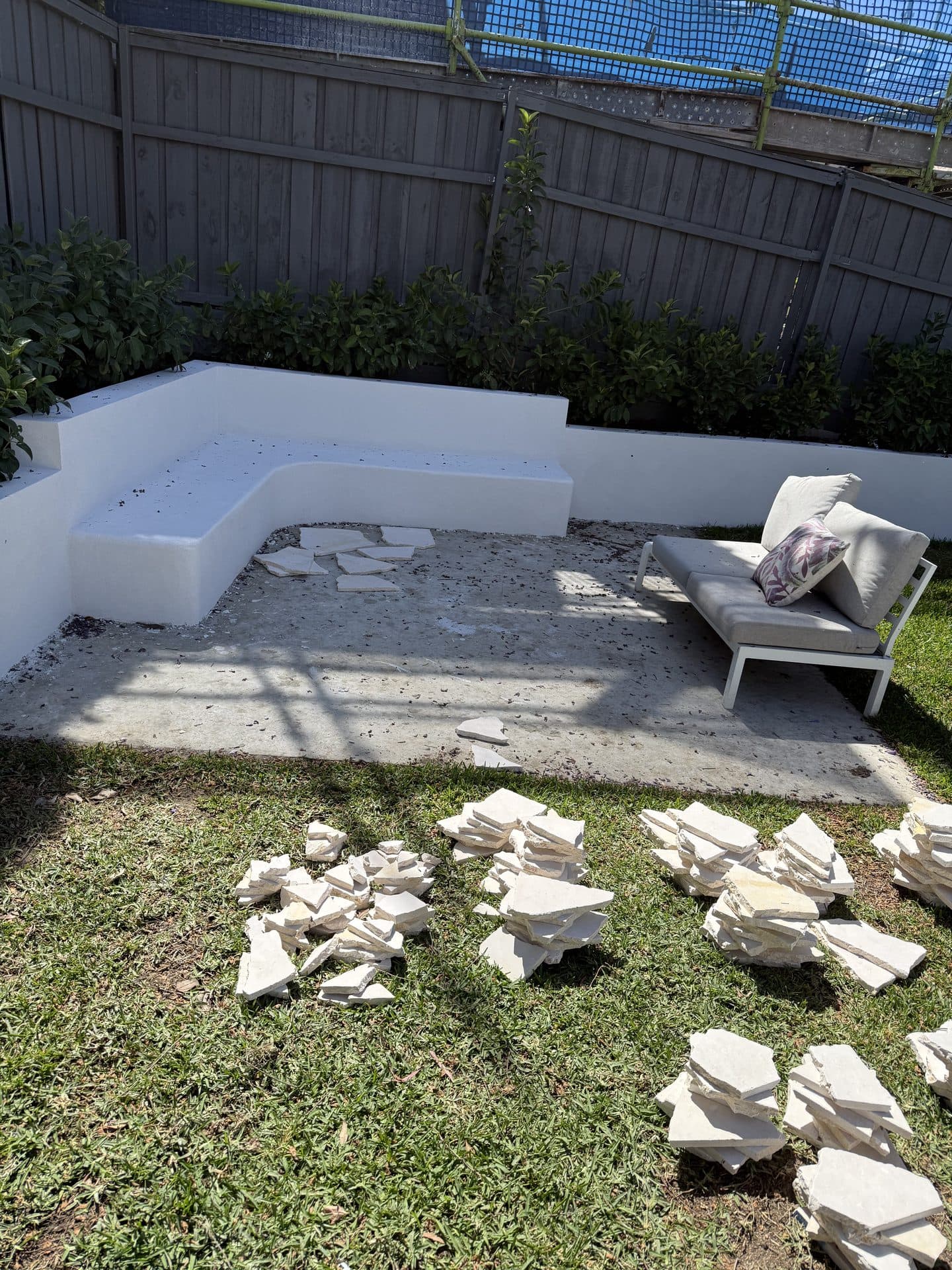 Outdoor courtyard with old crazy paving ripped up before tiling Sydney