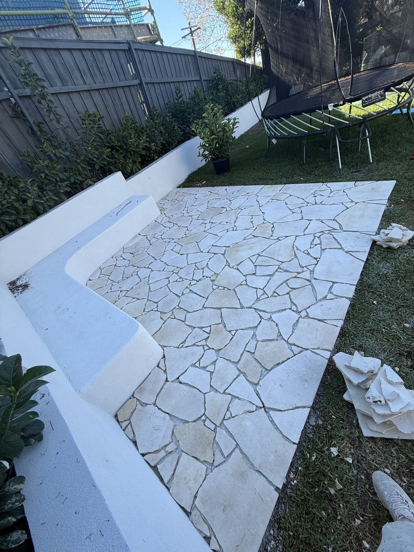 Outdoor courtyard with fresh crazy paving installed after tiling Sydney