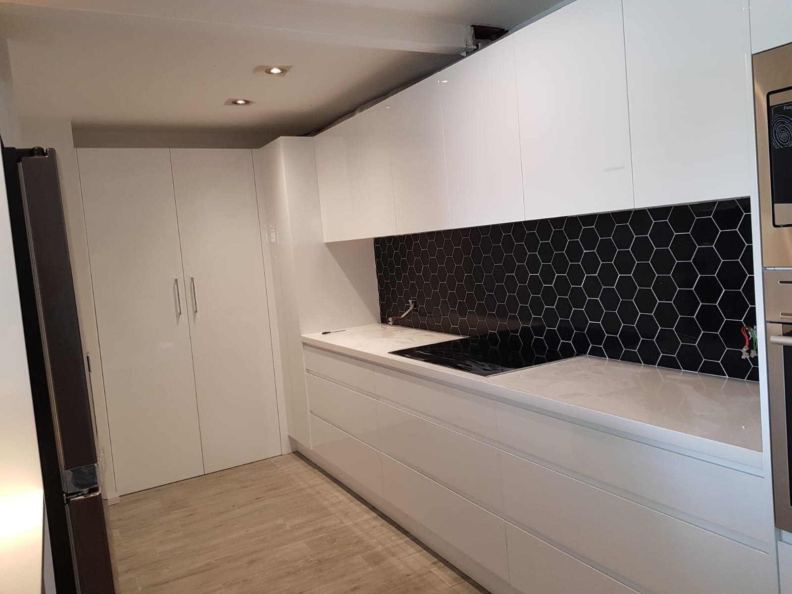 Black hex mosaic kitchen splashback installed by S & T Tiling Renovations Sydney